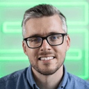 A man, green lights in the background
