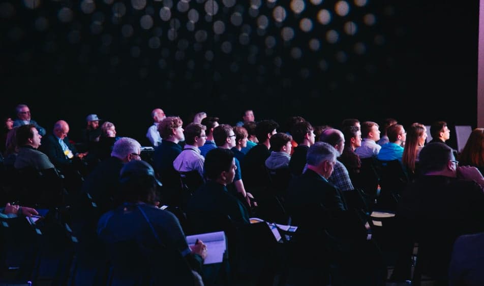 Audience at a conference, dark lights