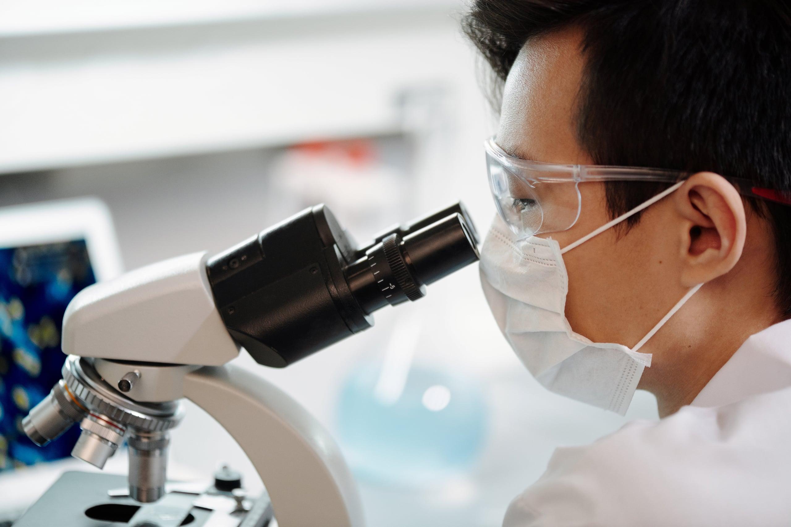 a doctor looking at a microscope